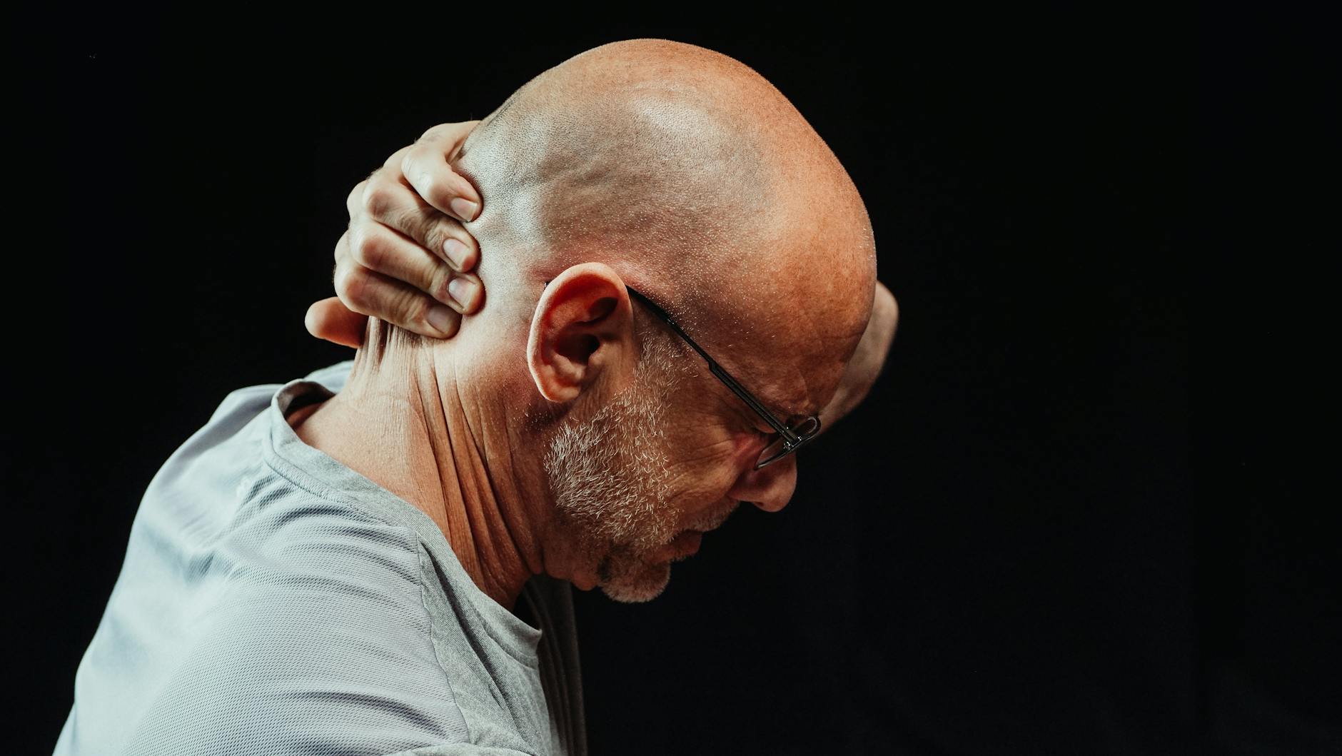 close up photo of man having a neck pain
