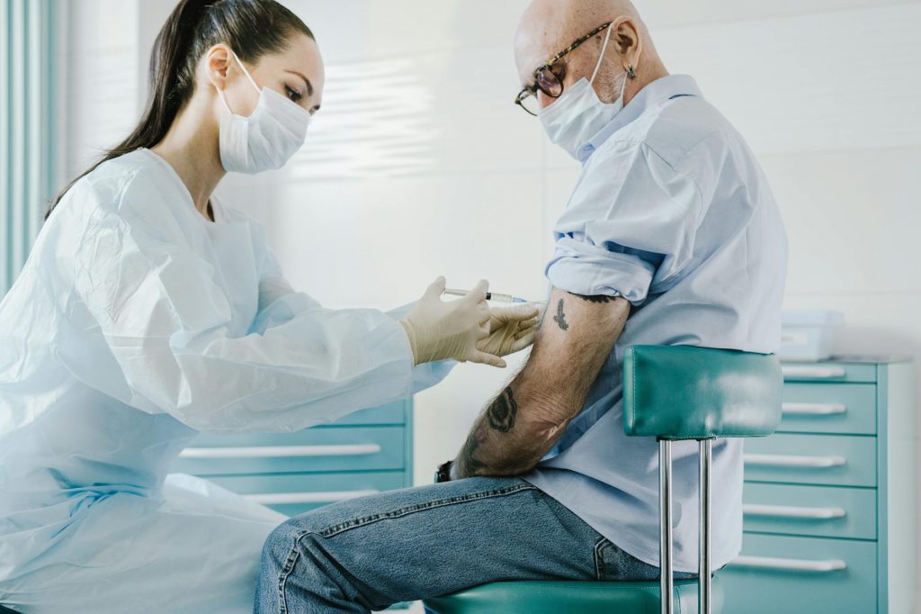 a doctor injecting a patient