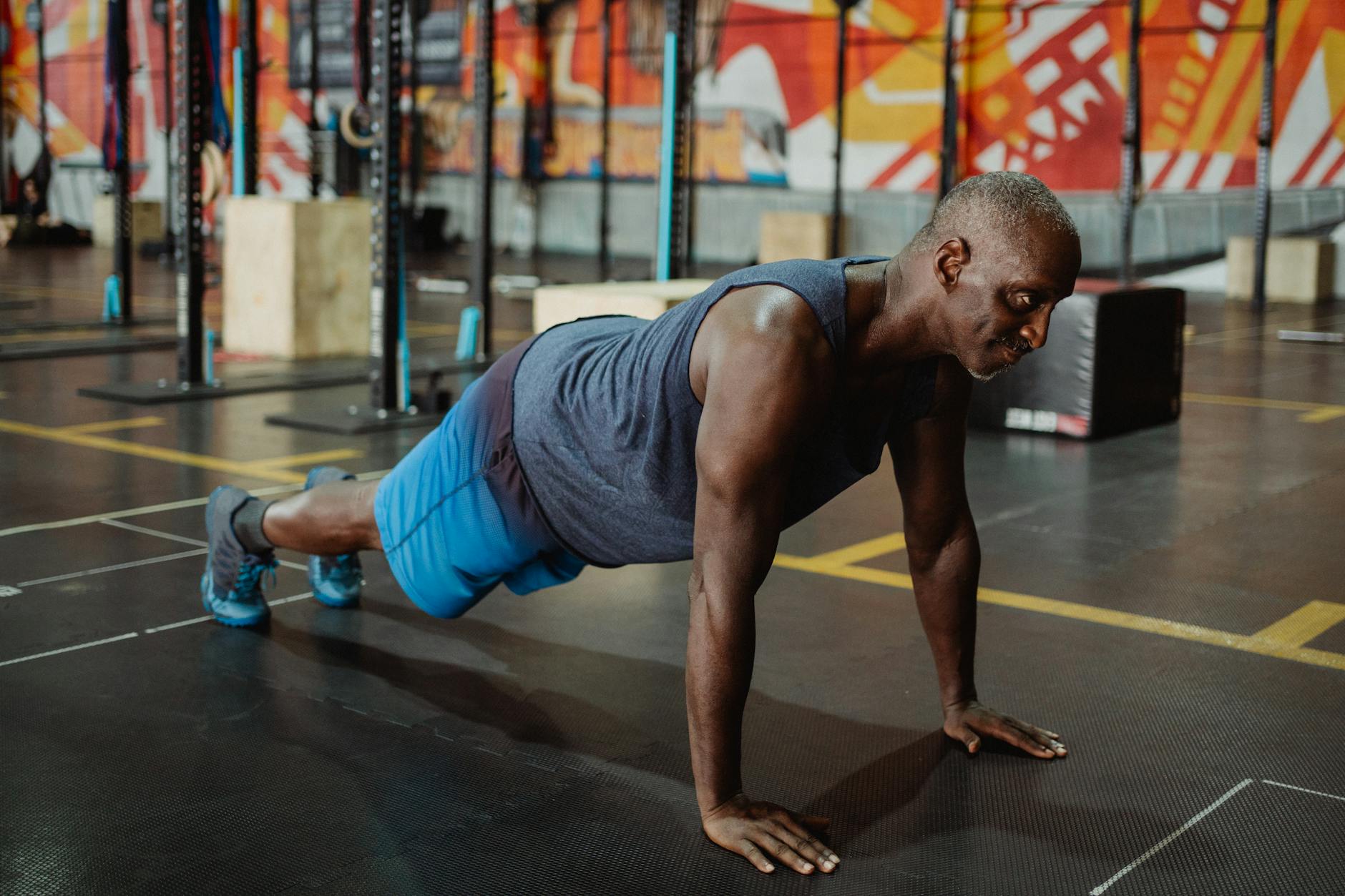 man in gray tank top doing push ups