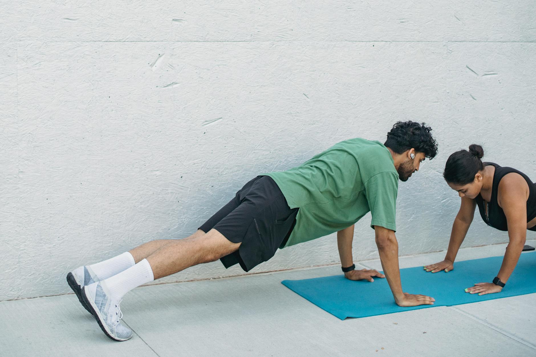 man and woman exercising in plank position