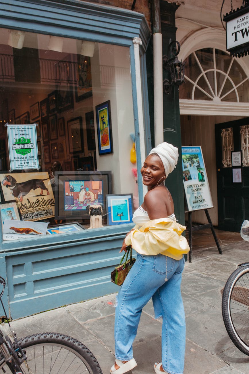 woman in a turban posing in front of a store