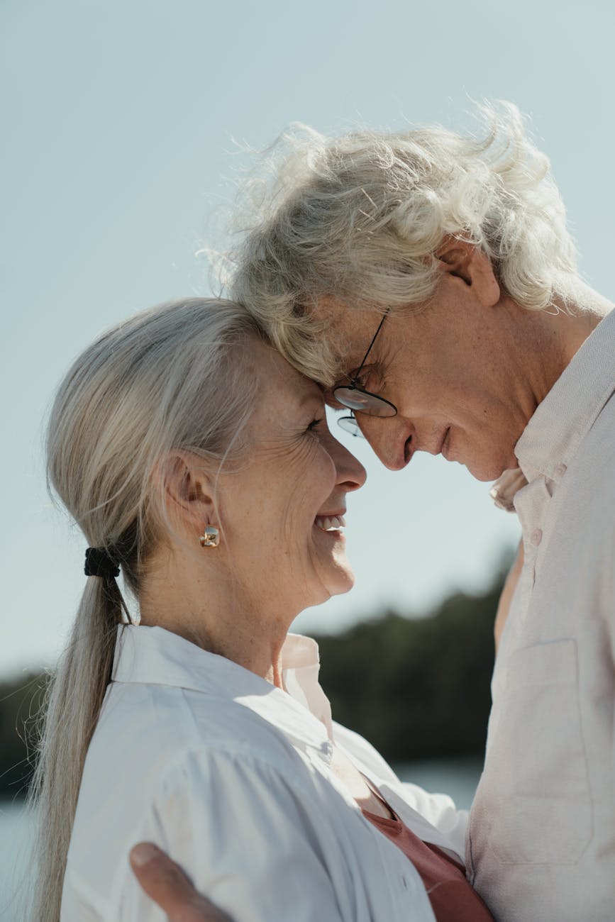 an elderly couple embracing