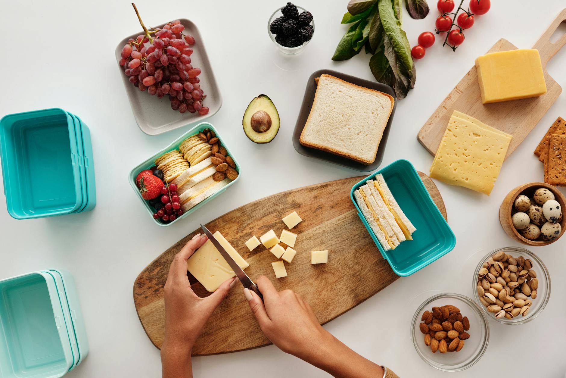 person cutting a block of cheese