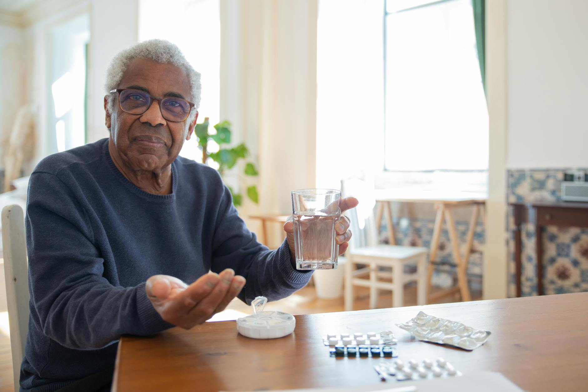 a man in blue sweater sitting at the table