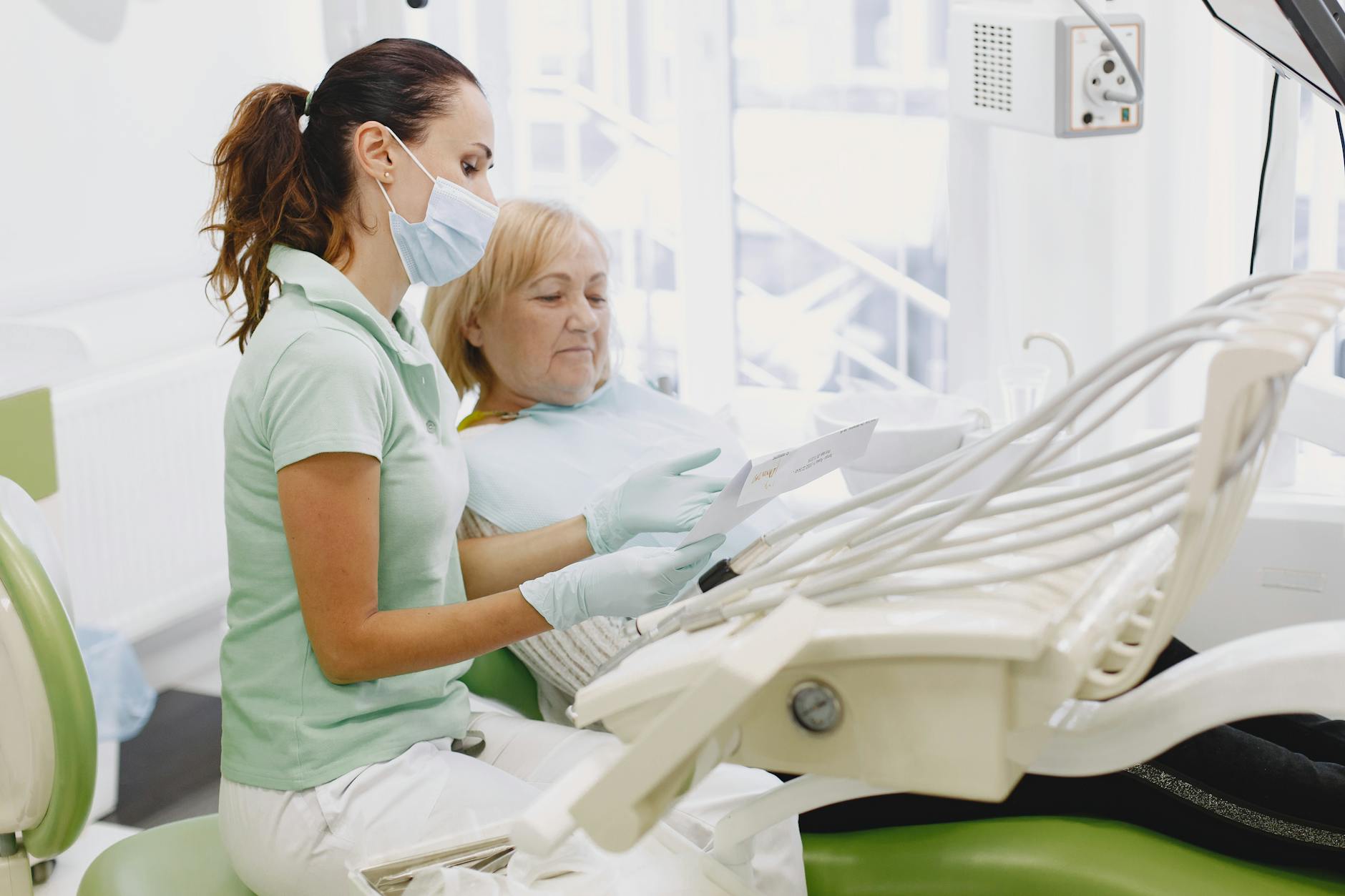 a dentist reading the diagnosis to a patient