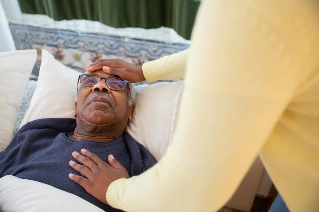 a man in blue sweater lying on the bed