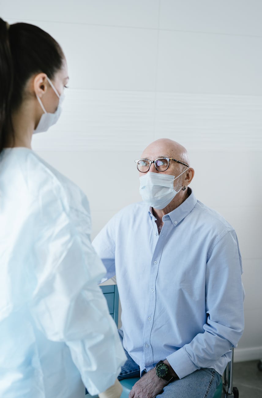 elderly man patient looking at his doctor